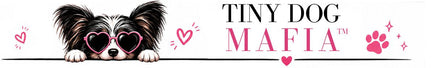 A stylized logo or label reading 'TINY DOG MAFIA' with a small black-and-white dog peeking over a line wearing heart-shaped sunglasses. Pink hearts, paw prints, and sparkles decorate the design on a white background.